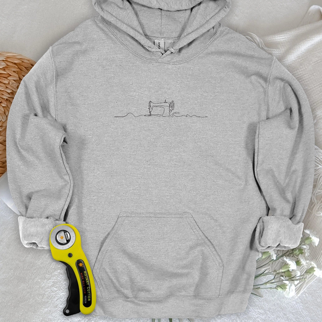 Sweat à capuche minimaliste avec machine à coudre